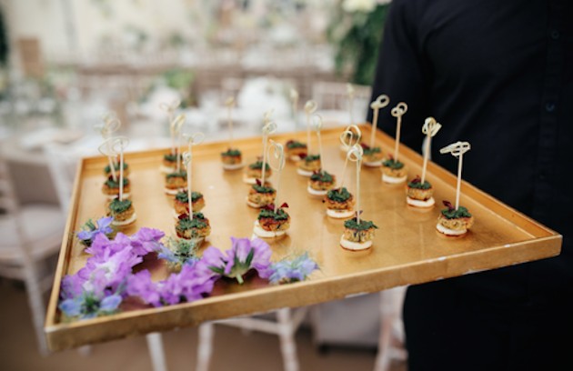 How can you work with a caterer to plan a unique wedding menu?